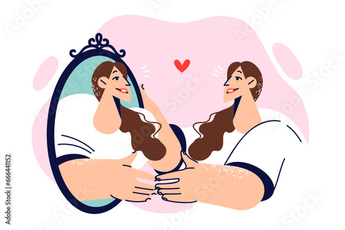 Woman looks in mirror rejoicing to see herself reflected, for concept of narcissism