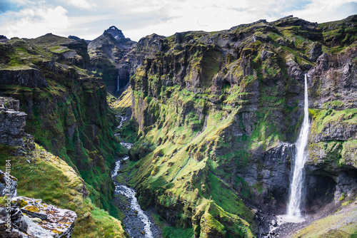 View of a beautiful waterfall along the canyon in southern region of Iceland.