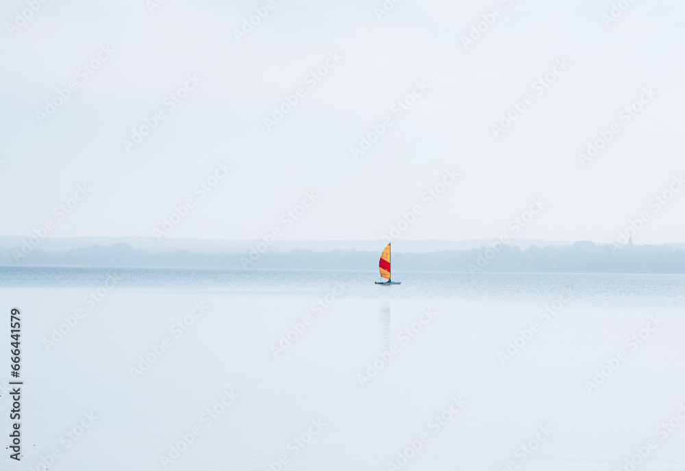 View of small sailing boat on lake Ammersee in Bavaria, Germany. View of small sailing boat on lake Ammersee in Bavaria, Germany.