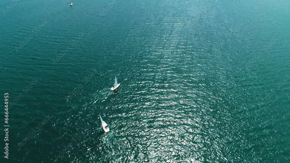 Sunfish sailboats on Spanish waters practice tacking against wind, Curacao