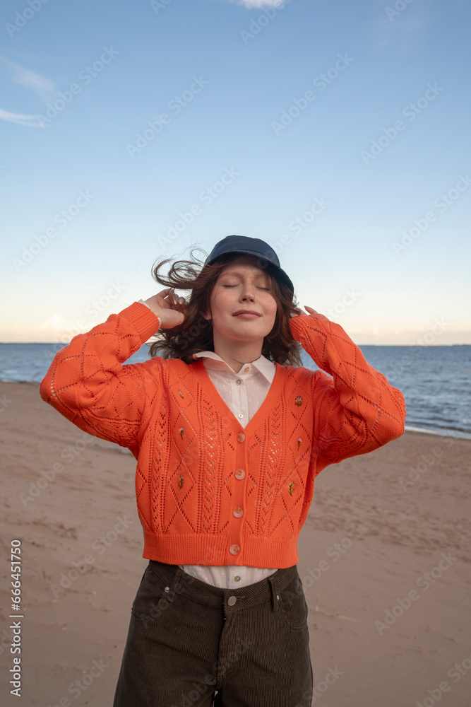 Young woman wearing hat standing at beach