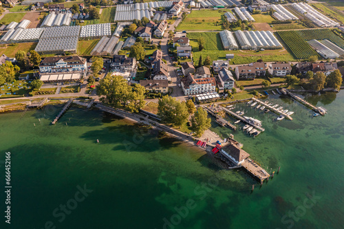 Germany, Baden-Wurttemberg, Aerial view of jetties on shore of Reichenau island with greenhouses in background photo