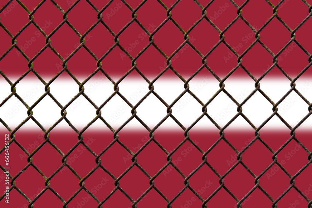 Fototapeta premium A steel mesh against the background of the flag Latvia.