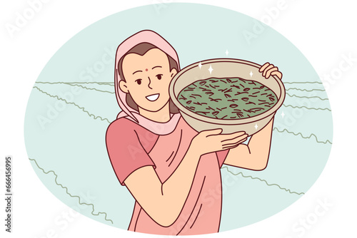 Smiling indian woman in traditional clothes show bowl working in field in countryside. Happy female worker collecting crop in rural grassland. Farming concept. Vector illustration.