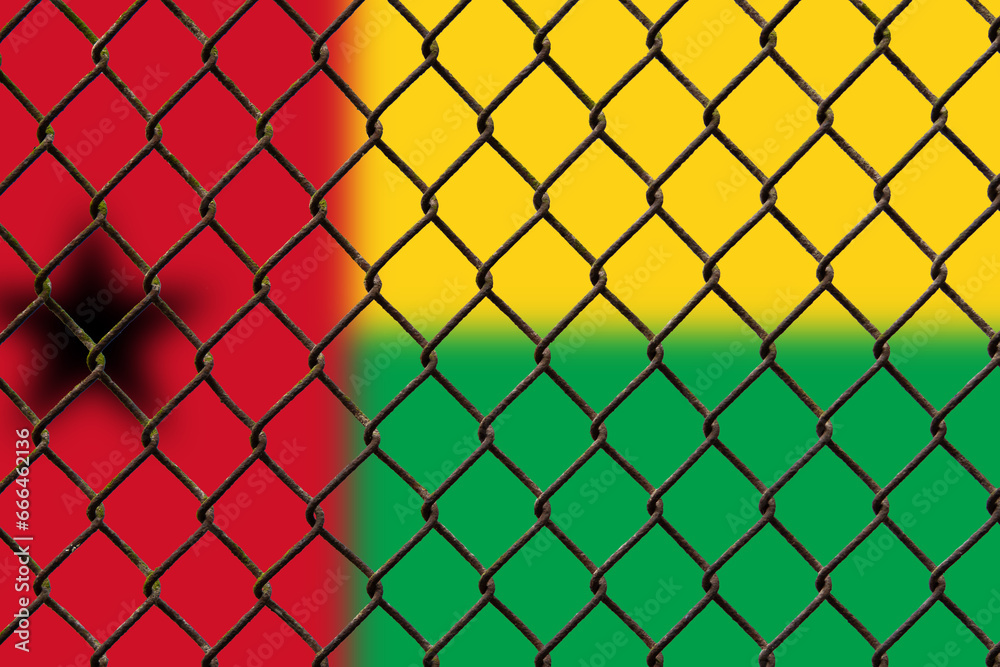 Fototapeta premium A steel mesh against the background of the flag Guinea-Bissau.