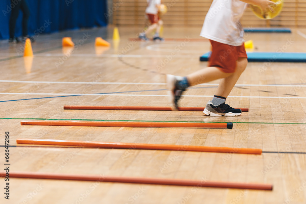 Futsal training field. Indoor football practice for children. Indoor soccer training during the winter. Futsal training field with orange poles yellow cones and red hurdles. Physical education 