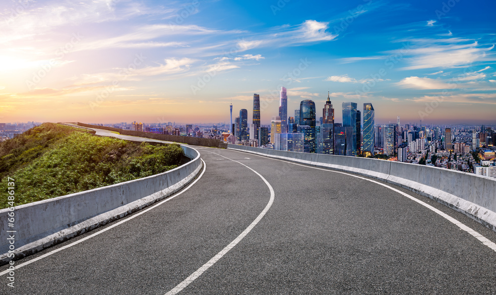 Asphalt highway and city skyline with modern buildings scenery at sunset in Guangzhou, Guangdong Province, China. Asphalt highway and city skyline with modern buildings scenery at sunset in Guangzhou, Guangdong Province, China.