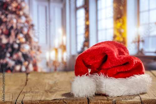 Red Santa Claus hat on table and free space for your decoration. 