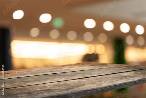 empty table to showcase your product on blurred golden bokeh cafe background. window bokeh