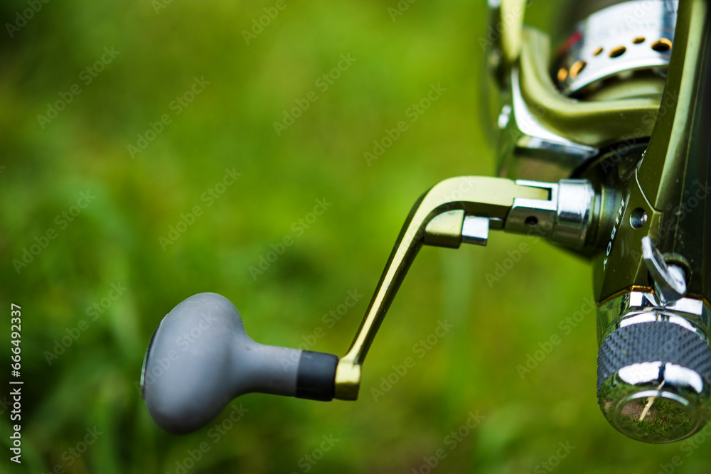 Fishing rod, spinning reel on the background of the pier on the river bank. Sunrise. Wild nature. Rural holiday concept. An article about a fishing day. Fishing rod, spinning reel on the background of the pier on the river bank. Sunrise. Wild nature. Rural holiday concept. An article about a fishing day.