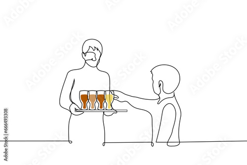 waiter is holding a tray of pints of beer of different types and man is reaching out to one of the glasses - one line art vector. concept Oktoberfest, beer lover, impatient guest or client at the bar
