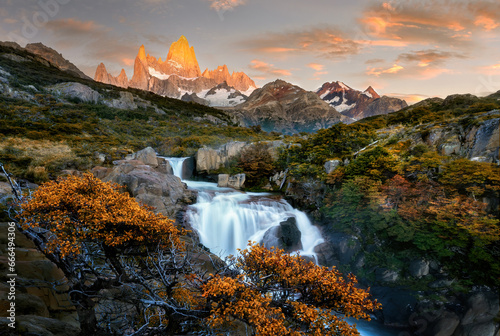 A waterfall with a mountain in the background photo
