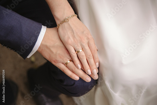 Hands of bride and groom with golden wedding rings  photo