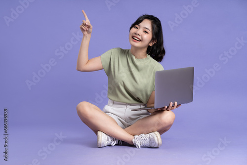 Portrait of beautiful asian woman posing on purple background © 1112000