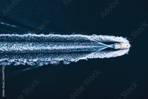 Motorboat floating in dark ocean photo