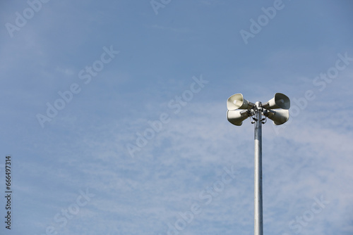 Whire horn speaker with cloud on blue sky background..