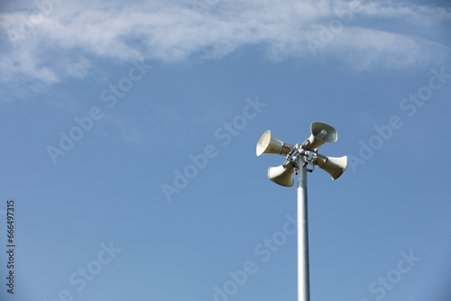 Whire horn speaker with cloud on blue sky background..