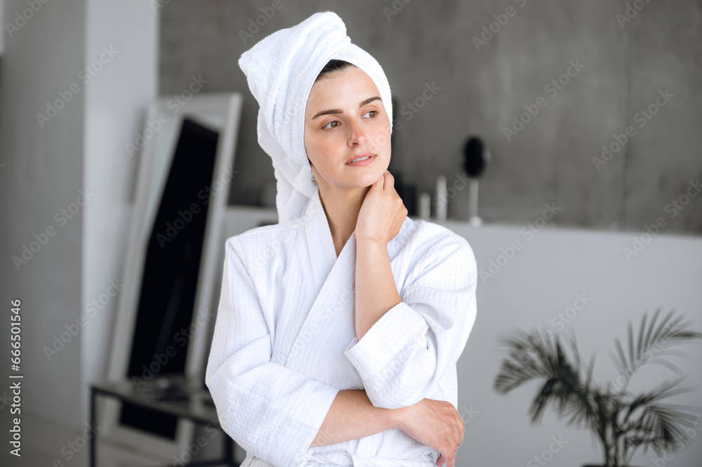 Young woman after spa procedures standing in bathrobe in luxury hotel Young woman after spa procedures standing in bathrobe in luxury hotel
