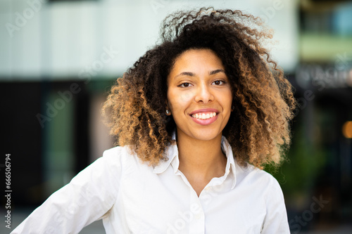 Confident young afro american female manager outdoor smiling