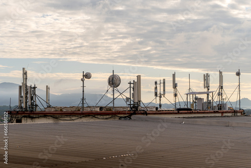 A rooftop bristling with telecom antennas, linking the sub urban with the world