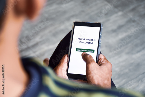 Cellphone with the message your account is deactivated. Reactivate a cancelled account concept. Digital display, selective focus.