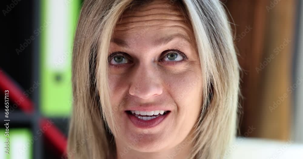 A smiling woman rolls her eyes, a close-up face. Facial expressions and gestures, concept of body language A smiling woman rolls her eyes, a close-up face. Facial expressions and gestures, concept of body language