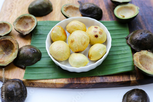 Djenkol fruit bean on wooden cutting board photo