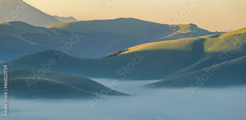 Fog and haze over castelluccio's hills photo