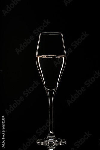 Backlit wine champagne glass with golden liquid