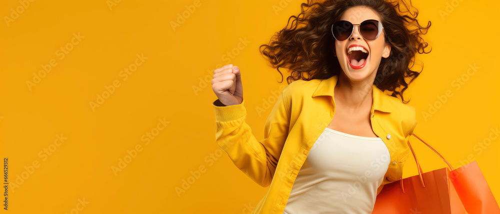Excited woman running with shopping bag on yellow background Excited woman running with shopping bag on yellow background