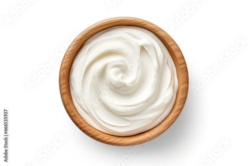 Top view of a white background isolated wooden bowl filled with sour cream or yogurt