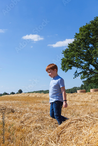 portrait of a seven-year-old boy in a field © rsooll