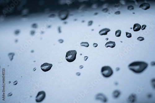 Raindrops cling to the car windshield, selective focus, soft focus.