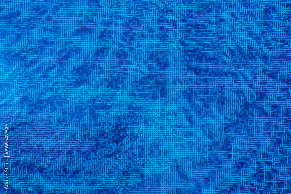 Light reflects off the surface of the blue swimming pool. Light reflects off the surface of the blue swimming pool.