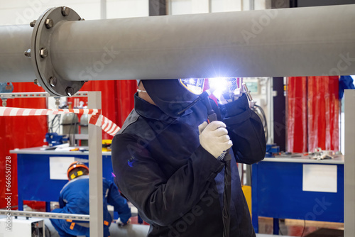 Welder repairs pipe. Man re...