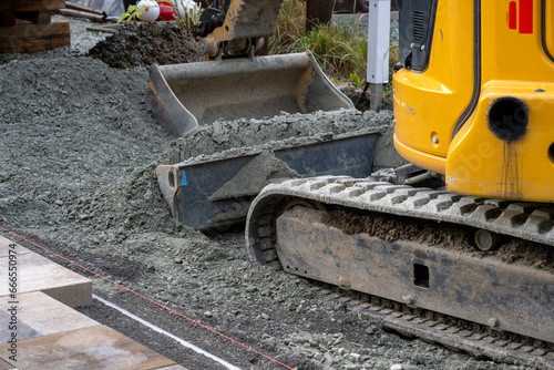 An excavator on a gravel surface © Richard Nantais