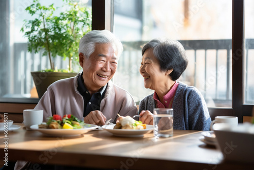 .Joyful Asian elderly man and woman or family spending time together having lunch in restaurant