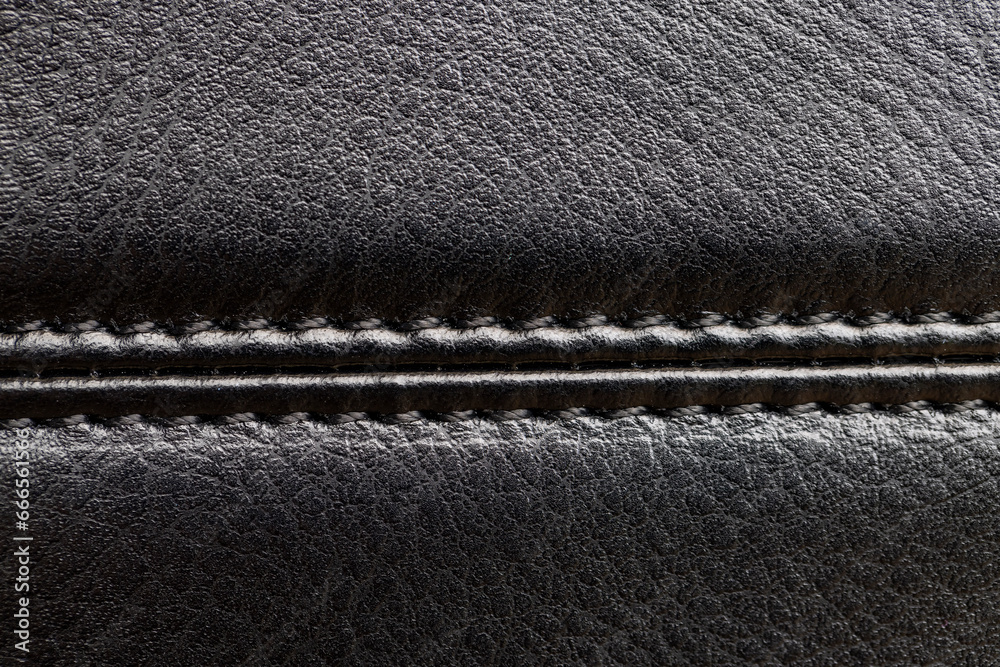 the seam at the junction of two pieces of black leather