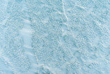 Frozen water surface with snow on it. Snowy ice. Background.