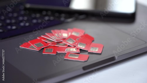 Many SIM cards on a laptop keyboard. Bot farm. Mobile gsm cards