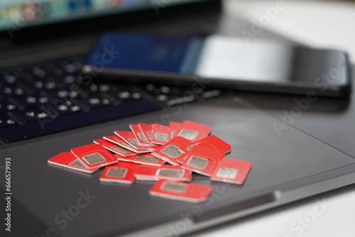 Many SIM cards on a laptop keyboard. Bot farm. Mobile gsm cards