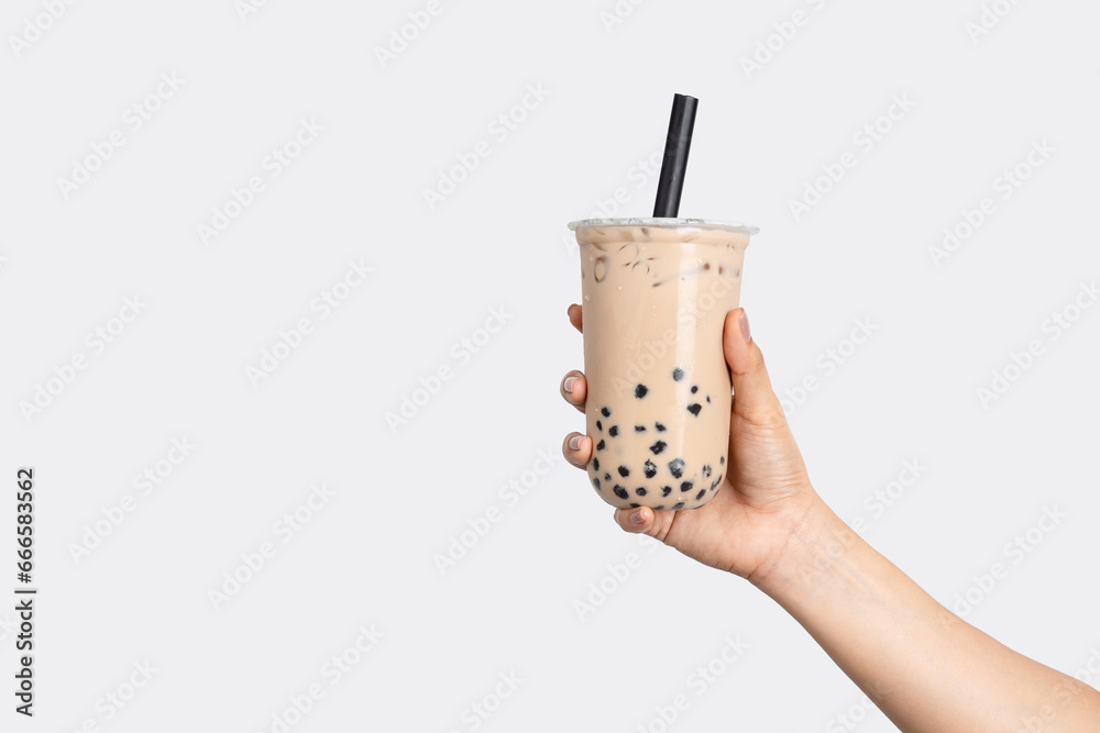 Fototapeta premium Hand holding bubble milk tea isolated on white background.