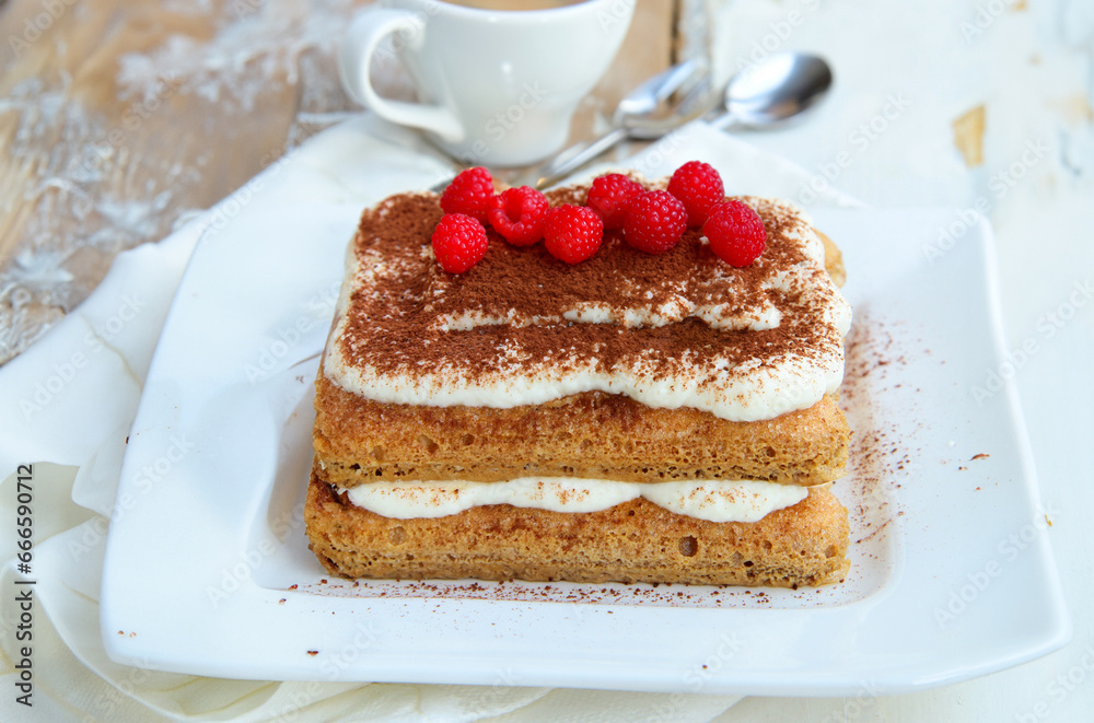 tiramisu cake with fresh berries on a plate for dessert tiramisu cake with fresh berries on a plate for dessert