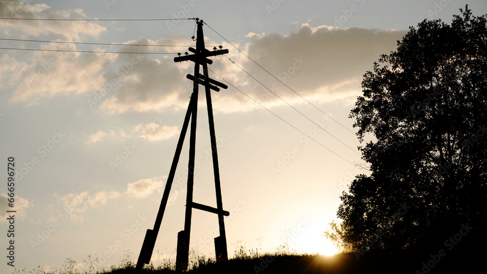 Obraz premium power line at sunset of the sun
