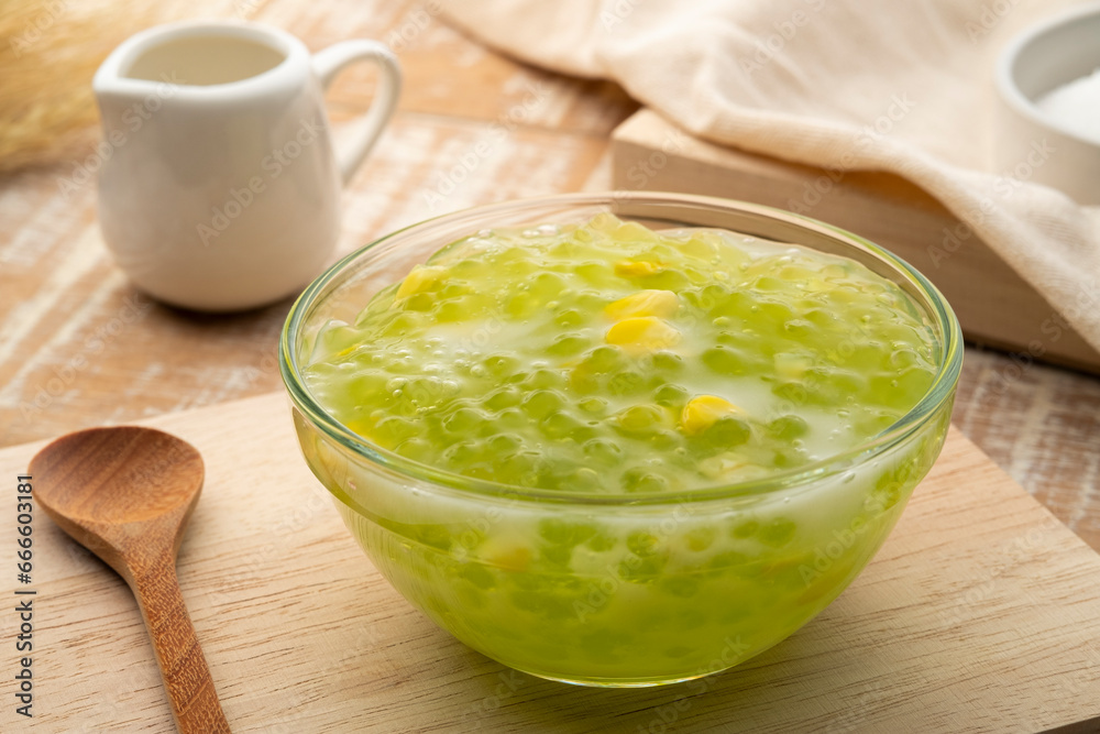 Pandan flavoured Tapioca pearl pudding (Sago) with a dash of coconut milk,popular South-East Asian dessert in glass bowl