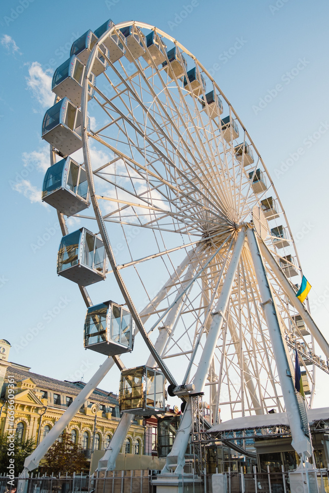 Tourist center with modern tourist attractions - ferris wheel in historical tourist spot in Kyiv - Kontraktova Square.