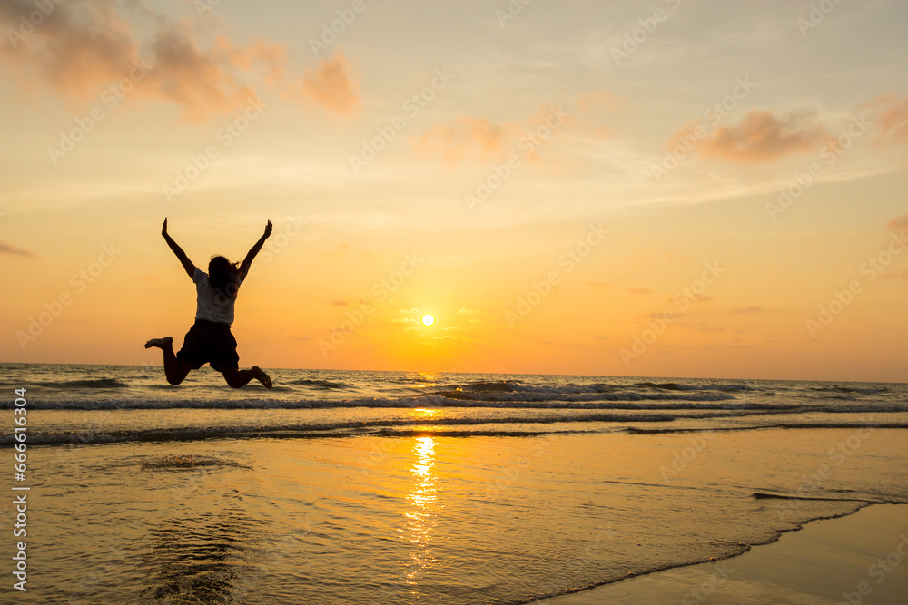 Happy Woman Jumping in Sea Sunset