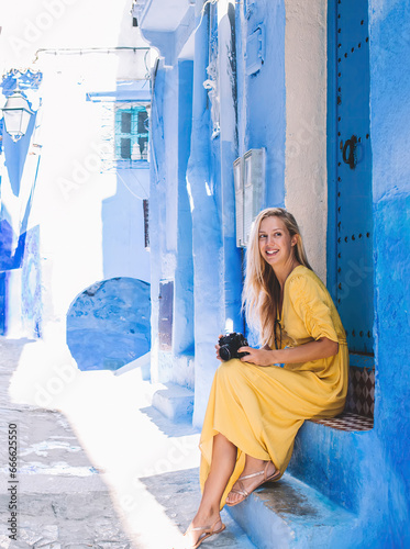 Cheerful tourist with camera resting on narrow street © BullRun