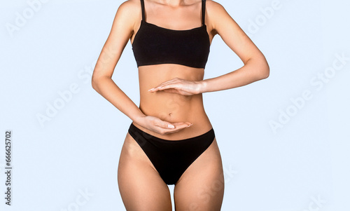 Stomach bowel good digestion food woman's medical health. Woman, stomach, ache. Health care concept, closeup. Young multi-ethnic woman's stomach. Closeup woman hands made protect shape stomach © Yevhen
