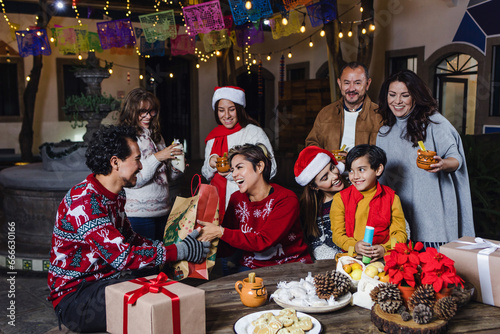 Fotografi Mexican Posada, Hispanic family Singing carols in Christmas celebration in Mexic